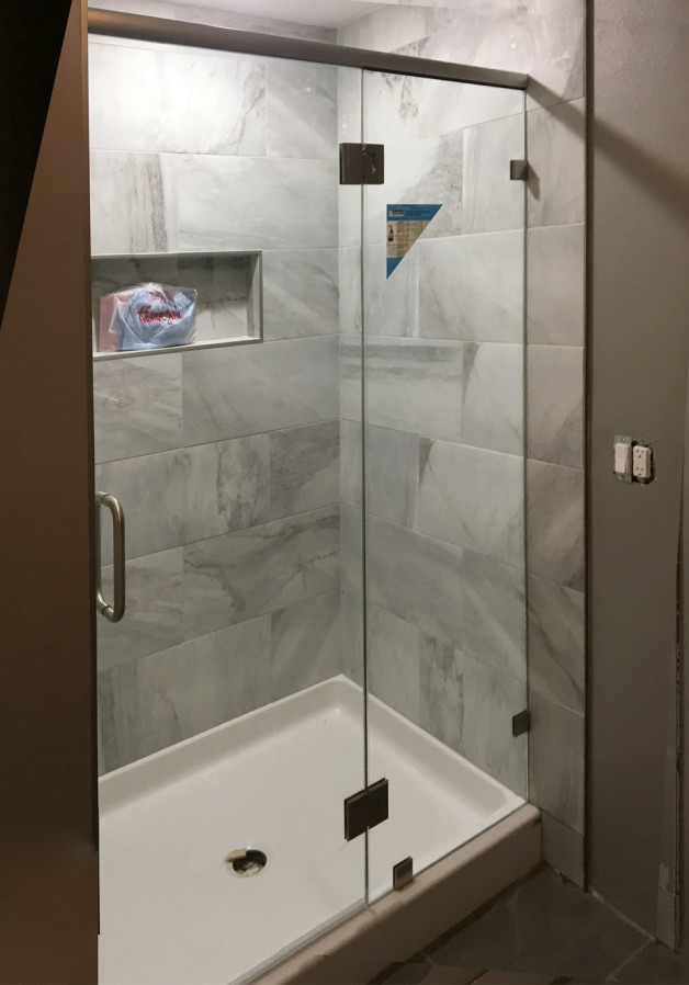 This custom brushed nickel shower has no u-channel and is treated with ClearShield!