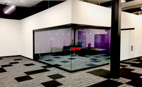 Glass conference room with architectural swing doors
