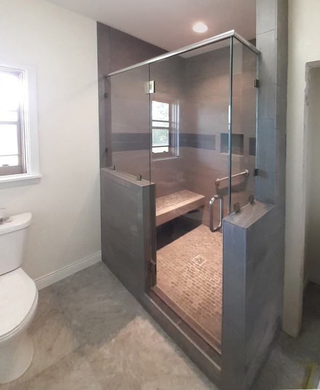 custom fit heavy glass shower has full door but half walls