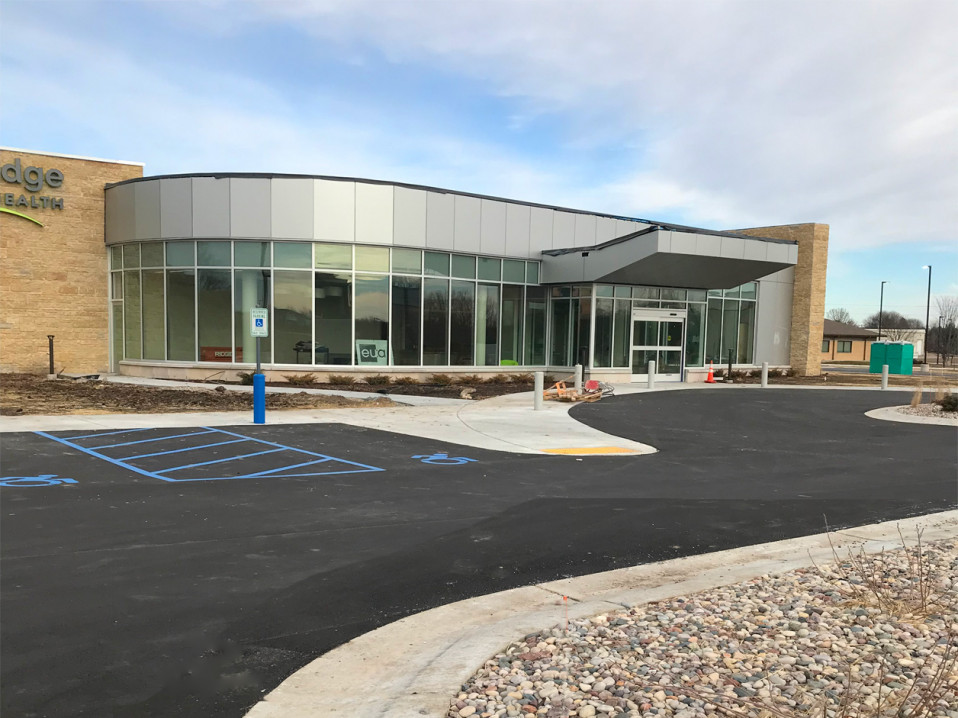 medical clinic has segmented curtain wall - EUA sign in window